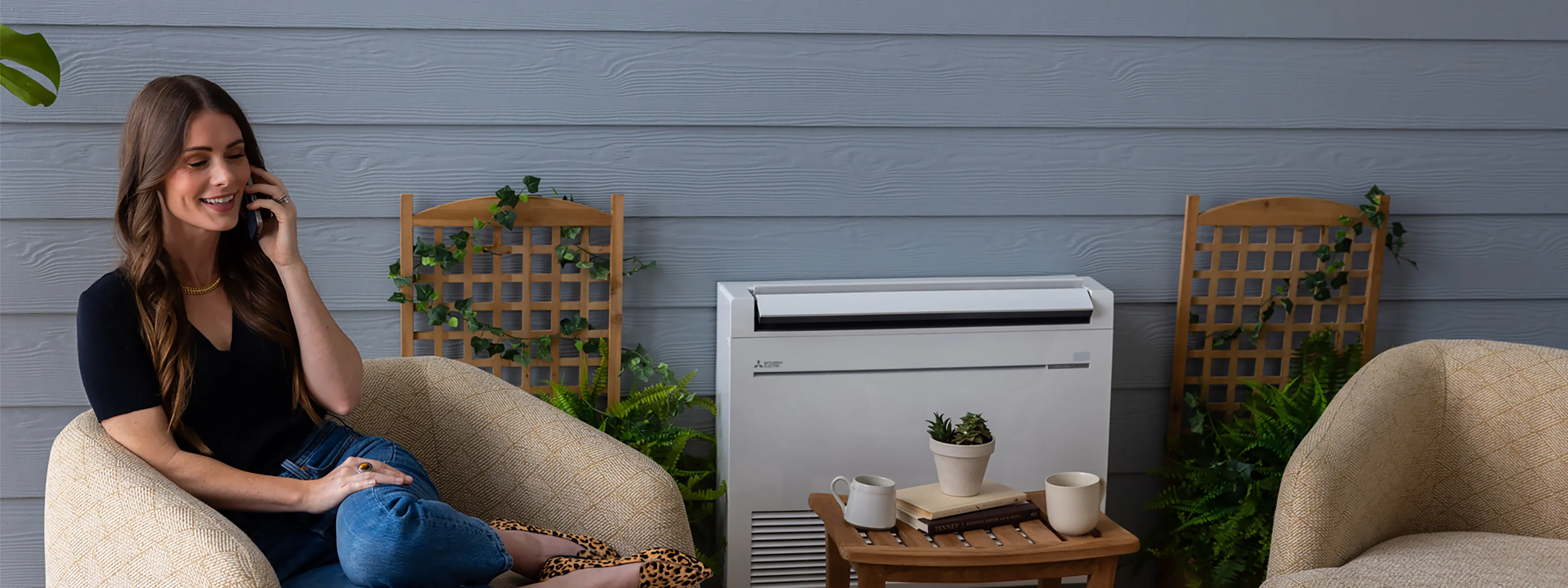 Woman enjoying phone conversation in sunroom by indoor floor-mount unit